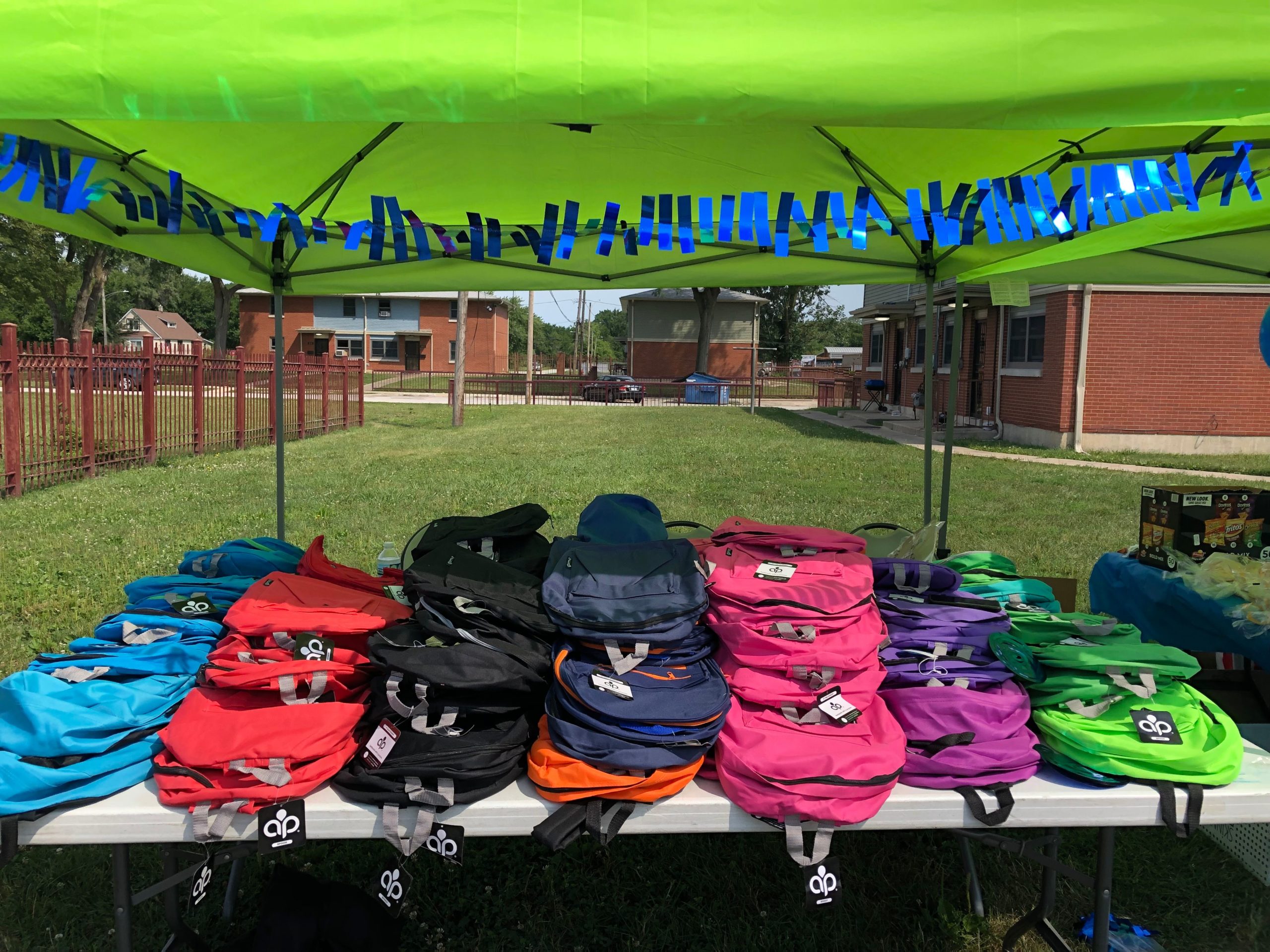 A stack of color backpacks for back to school event